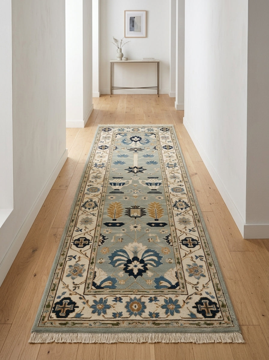 Hand Knotted Oushak Runner Rug in soft blue wool, with navy and copper floral urn motifs, an ivory border and fringe.