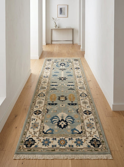 Hand Knotted Oushak Runner Rug in soft blue wool, with navy and copper floral urn motifs, an ivory border and fringe.