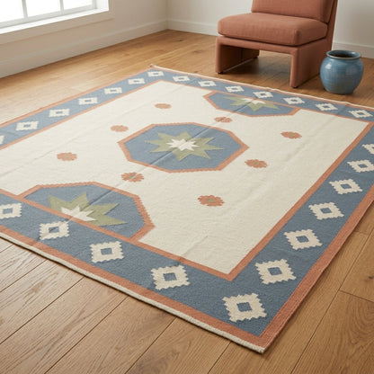Southwestern Flatweave Wool Rug in ivory with dusty blue, peach and sage star medallions and a geometric border.