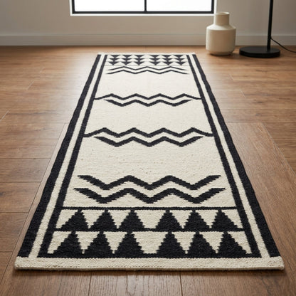 Runner rug, ivory wool with bold black zigzags, geometric triangles and double-line borders; Hand Knotted Oushak Runner Rug