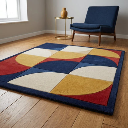 Handmade Retro Rug, a wool tufted carpet in navy, red, mustard and ivory with bold curved geometric blocks and a navy border.