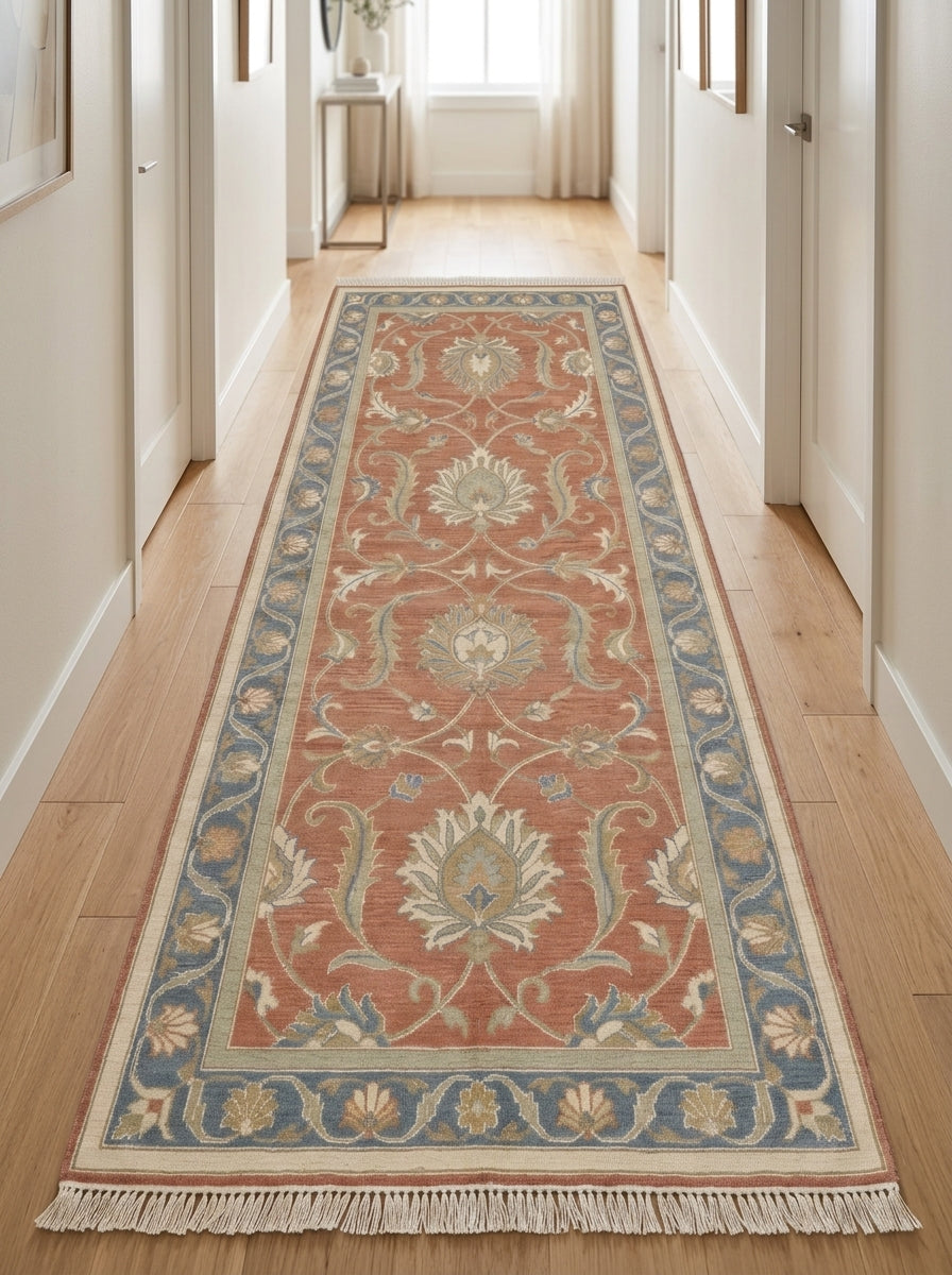 Hand Knotted Oushak Runner Rug in terracotta wool, with ivory floral vines, sage accents, a blue border and fringed ends.