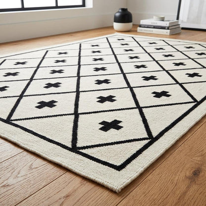 Southwestern Flatweave Wool Rug in ivory with bold black diamond lattice, cross motifs, and a narrow dark border.