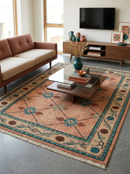 Terracotta Teal Trellis Hand Knotted Wool Area Rug in faded coral with teal medallions, floral border and fringed ends.