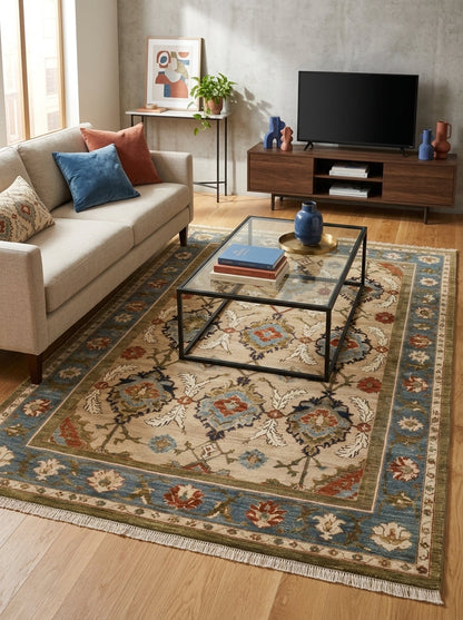 Oushak Hand Knotted Rug in camel beige wool, featuring a floral palmette lattice, slate blue border and fringe edges.