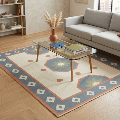 Southwestern Flatweave Wool Rug in ivory with dusty blue, peach and sage star medallions and a stepped geometric border.