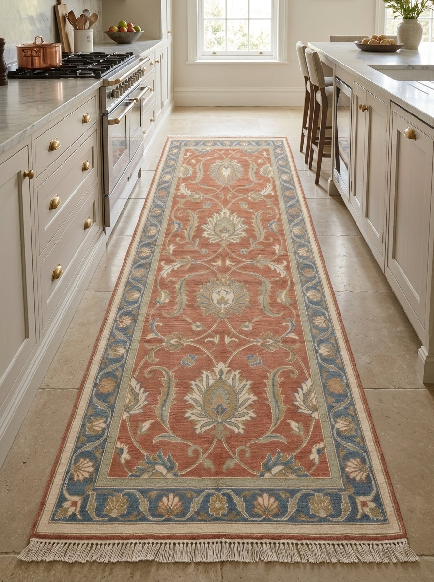 Hand Knotted Oushak Runner Rug in wool, with a terracotta floral vine pattern, blue border and fringed ends.