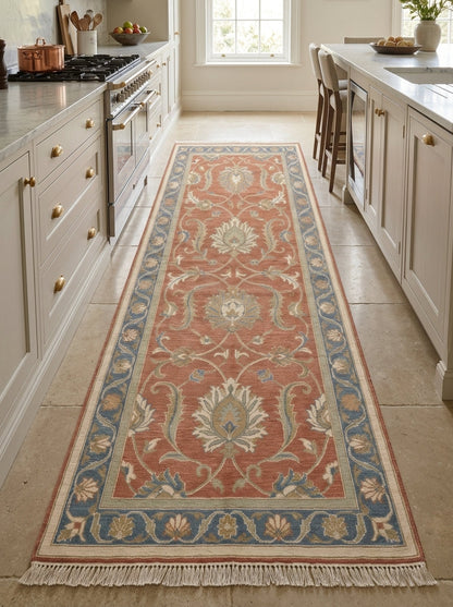 Hand Knotted Oushak Runner Rug in wool, with a terracotta floral vine pattern, blue border and fringed ends.