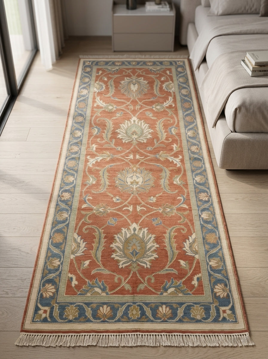 Hand Knotted Oushak Runner Rug with a terracotta wool field, ivory floral vines and sage motifs, blue border and fringe.
