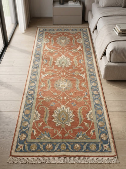 Hand Knotted Oushak Runner Rug with a terracotta wool field, ivory floral vines and sage motifs, blue border and fringe.