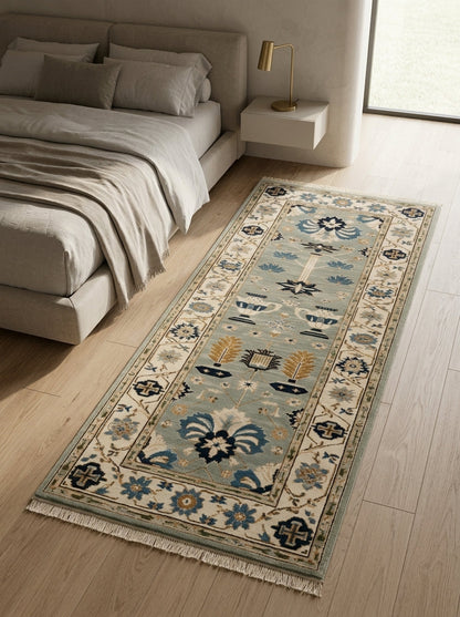 Hand Knotted Oushak Runner Rug in soft blue wool, with ivory floral borders, navy and copper garden motifs, and fringed ends.