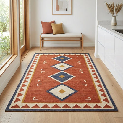 Southwestern Flatweave Wool Rug with a rust red field, navy and ivory stepped diamonds, mustard accents, and a geometric ivory border.