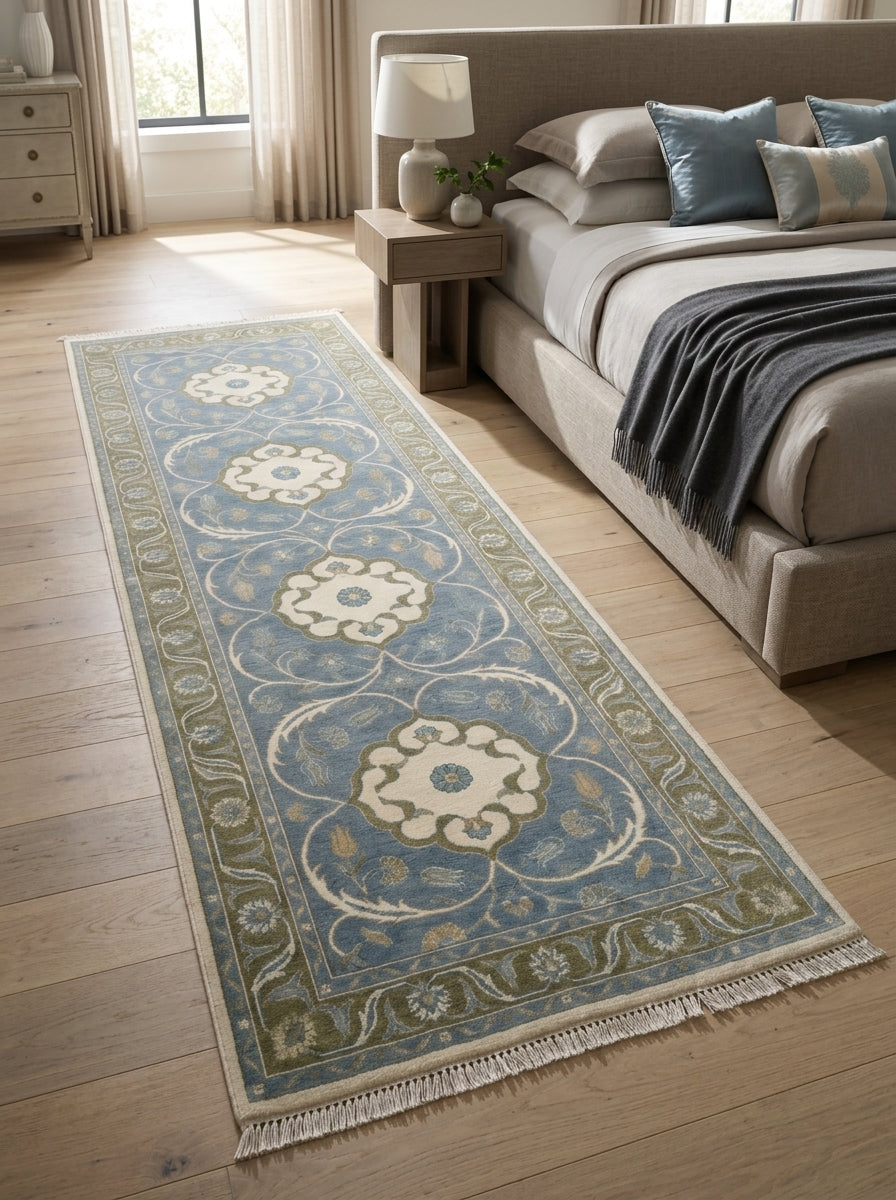 Hand Knotted Oushak Runner Rug in wool, with a light blue field, ivory floral medallions and olive vine border, finished with fringe.