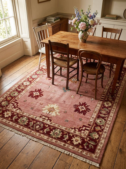 Oushak Hand Knotted Rug in dusty rose wool, with scattered floral motifs, burgundy floral border and fringed ends.