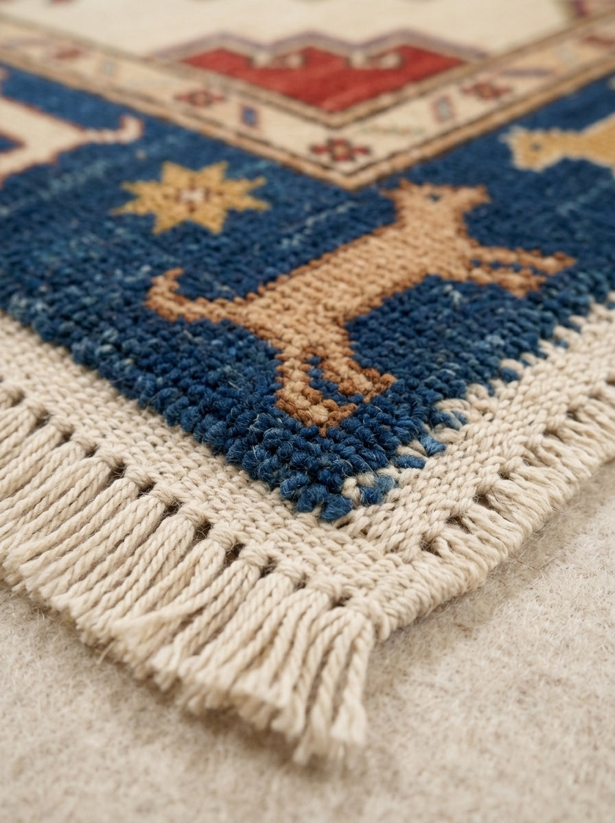 Hand Knotted Oushak Runner Rug with a thick wool pile, navy and camel animal motifs, ivory edging and long fringe.