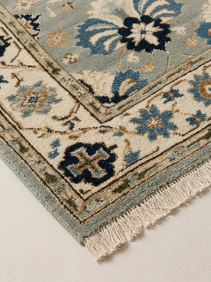 Hand Knotted Oushak Runner Rug in soft blue wool, with ivory floral border, navy and copper motifs, and fringe.