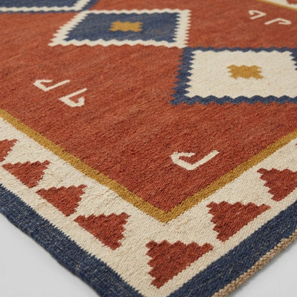 Southwestern Flatweave Wool Rug in rust red, ivory, navy and mustard, with diamond motifs and stepped triangle border.
