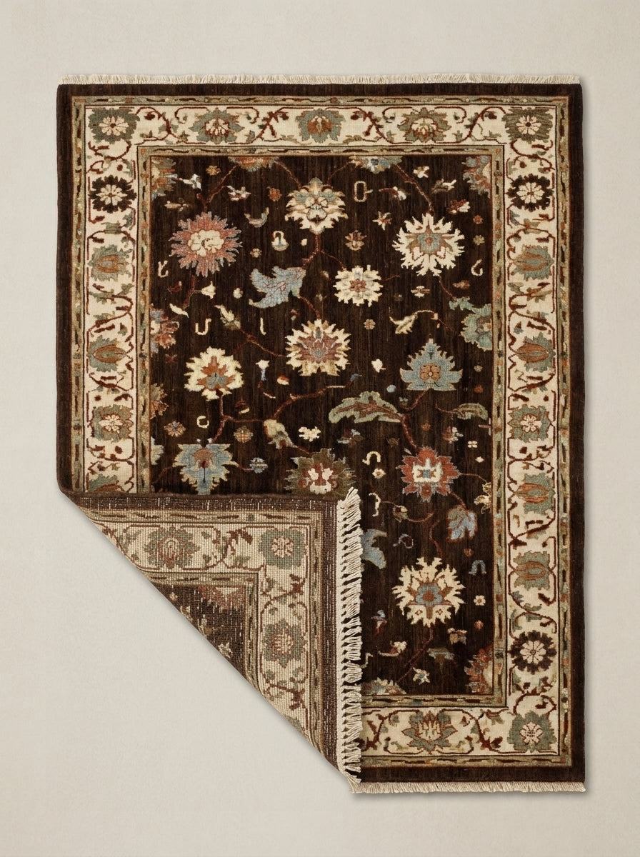 Oushak Hand Knotted Rug in chocolate brown wool, with multicolour floral motifs, ivory palmette border and fringed ends.