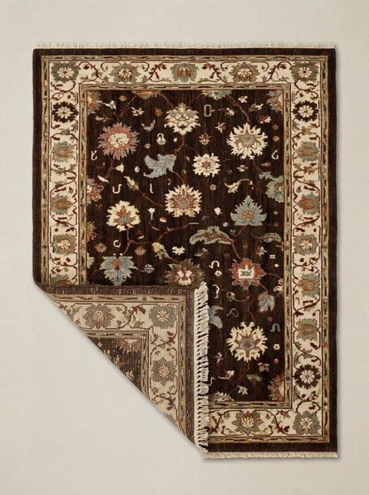 Oushak Hand Knotted Rug in chocolate brown wool, with multicolour floral motifs, ivory palmette border and fringed ends.