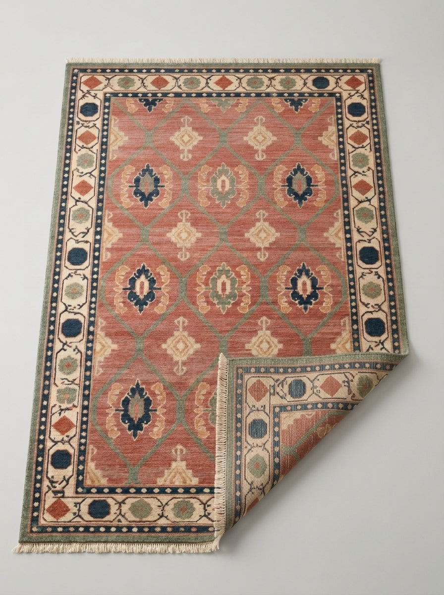 Oushak Hand Knotted Rug in coral pink wool, with sage lattice, multicolour medallions, ivory border and fringed ends.