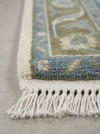 Hand Knotted Oushak Runner Rug in wool, with a muted blue and olive floral medallion pattern, ivory fringe and border.