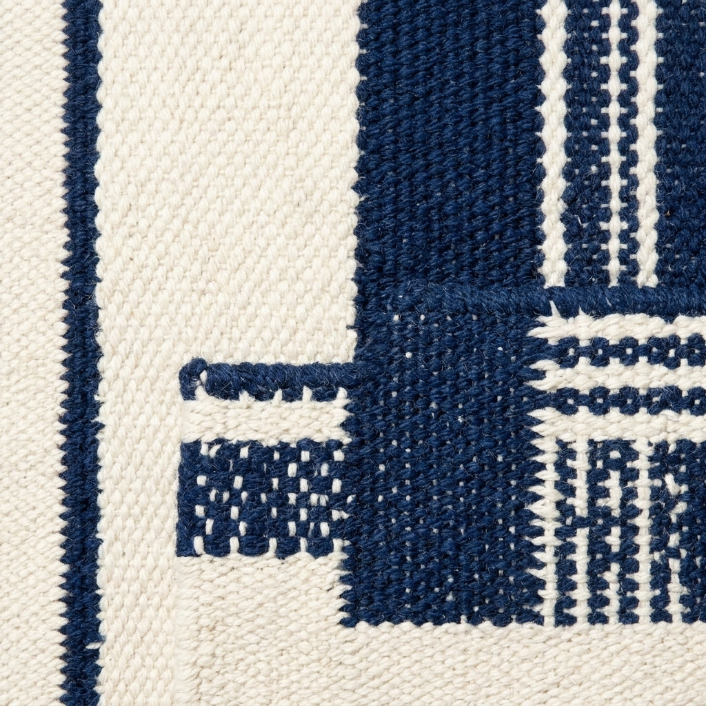 Southwestern Flatweave Wool Rug in navy and ivory, with bold stripes, fine pinstripes and textured woven details.