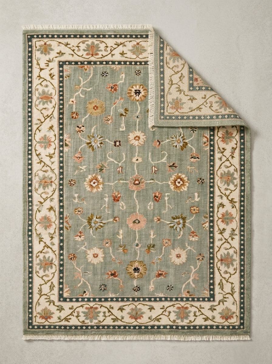 Oushak Hand Knotted Rug in muted sage wool, with scattered floral vines, an ivory floral border and deep teal dotted bands.