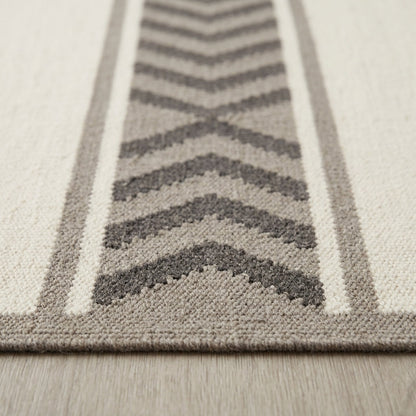 Southwestern Flatweave Wool Rug with ivory, taupe and charcoal chevron bands, textured woven surface and taupe border.