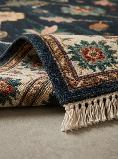 Oushak Hand Knotted Rug in deep navy wool with ivory, rust and green florals, patterned border and fringe.