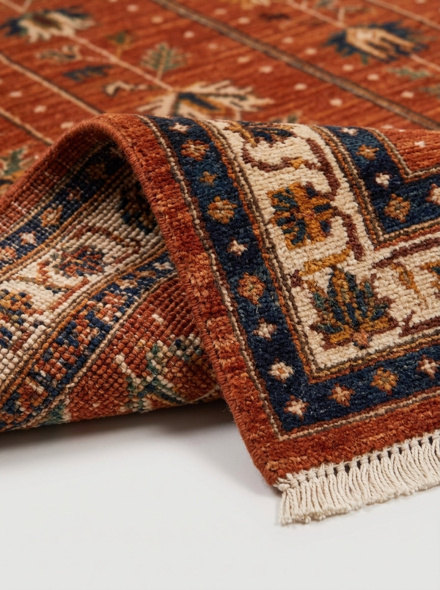 Oushak Hand Knotted Rug in rust red wool with ivory, navy and green floral motifs, bordered design and fringe ends.
