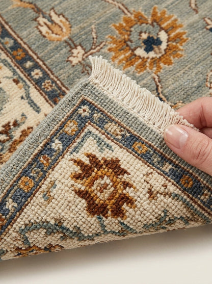 Oushak Hand Knotted Rug in sage gray wool, with ivory floral border, rust and gold blossoms, and fringe edging.