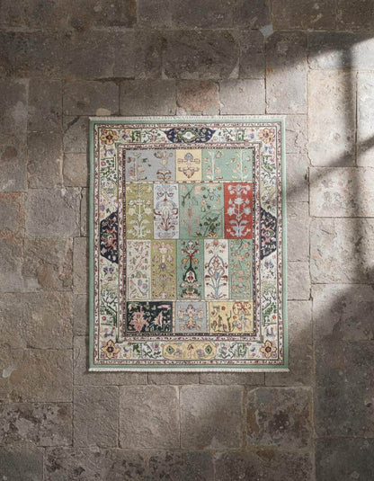 Pastel floral patchwork area rug with vintage botanical tiles and fringed edges in soft mint, sage, sky blue, ivory, and terracotta tones