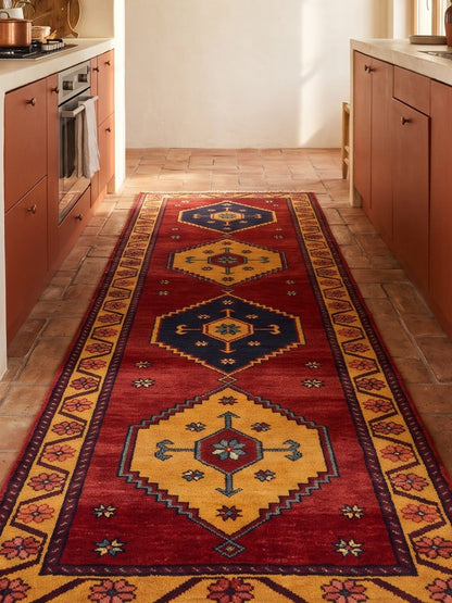 Red Tribal Runner Rug with wine-red wool field, golden stepped diamond medallions, navy accents and floral border