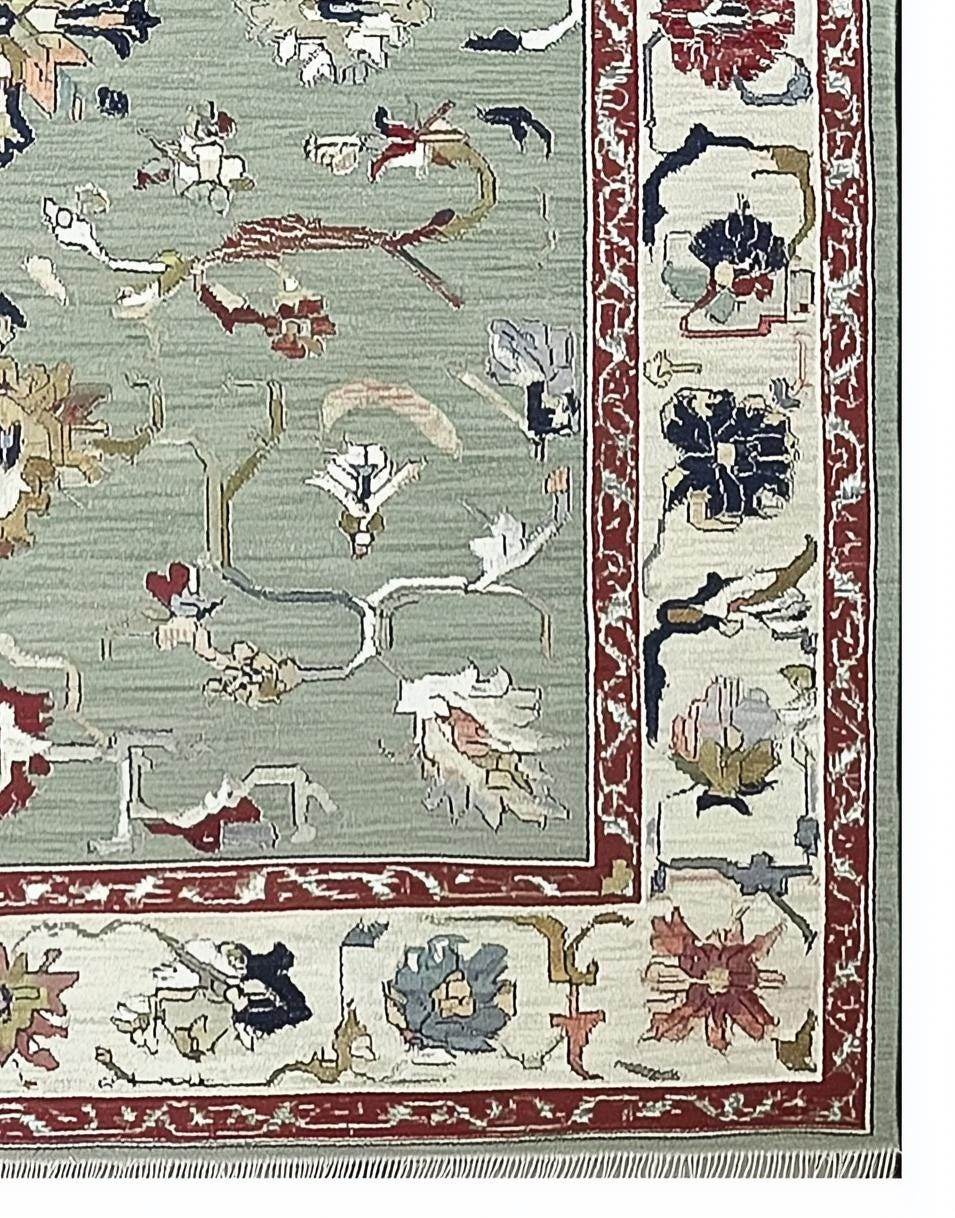 Sage green Oushak rug with hand-tufted wool floral and vine pattern, muted terracotta and cream borders, vintage Turkish design