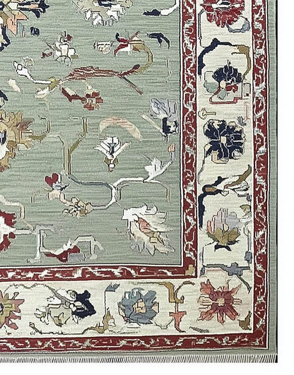 Sage green Oushak rug with hand-tufted wool floral and vine pattern, muted terracotta and cream borders, vintage Turkish design