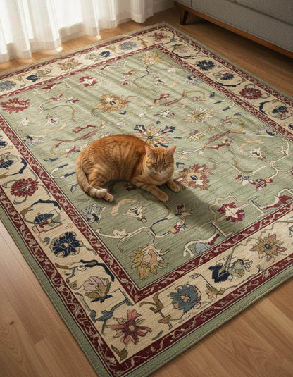 Sage green Oushak rug with hand-tufted wool, floral and vine patterns, featuring muted terracotta and cream borders.