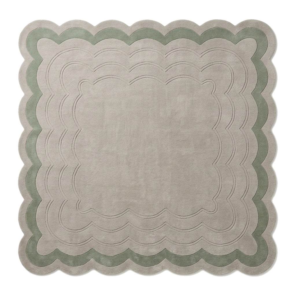 Sage Green Scalloped Echo hand-tufted wool rug in pale greige and sage green, with carved rippling lines and scalloped edges.