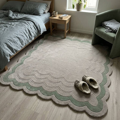 Sage Green Scalloped Echo wool rug in pale greige with a sage green border and carved scalloped lines.