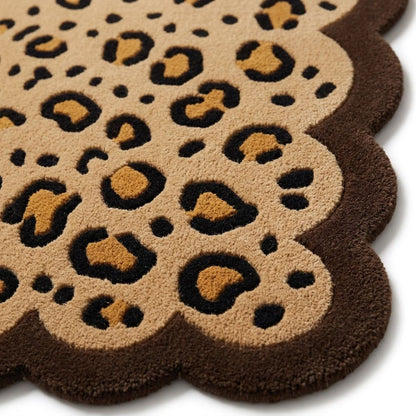 Scalloped Leopard Rug in plush tan wool with black and caramel rosettes and a deep brown wavy border