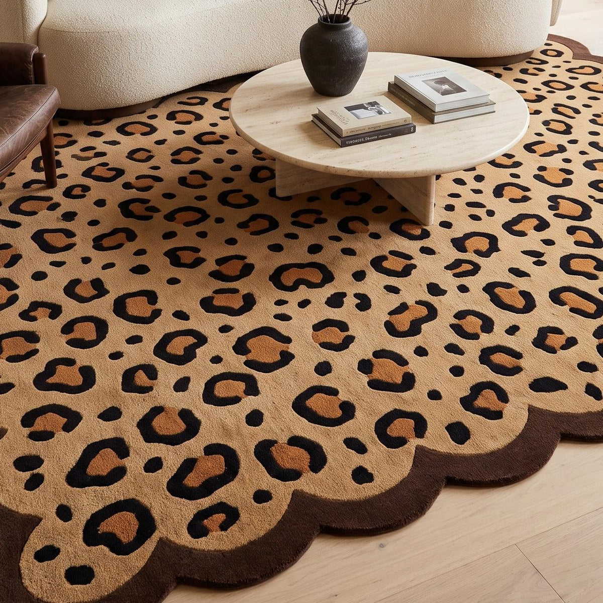 Scalloped Leopard Rug in tan wool with black and caramel rosettes and a dark brown wavy edge