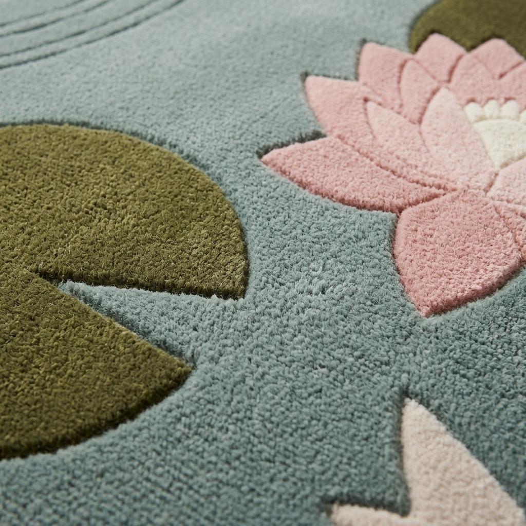 Seafoam Koi Fish Rug with a tufted wool surface, olive lily pad, blush pink water lily and white koi detail