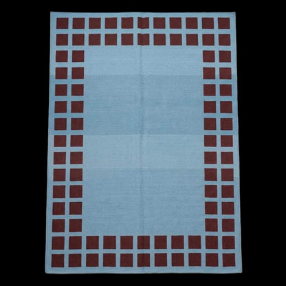 Handwoven sky blue dhurrie rug with maroon square border flatweave design