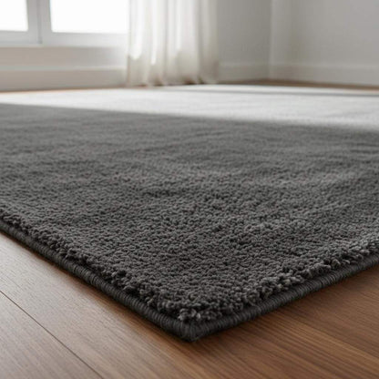 Soft plush grey rug with dense non-shaggy pile, modern rectangular design, and dark grey tone for contemporary living spaces
