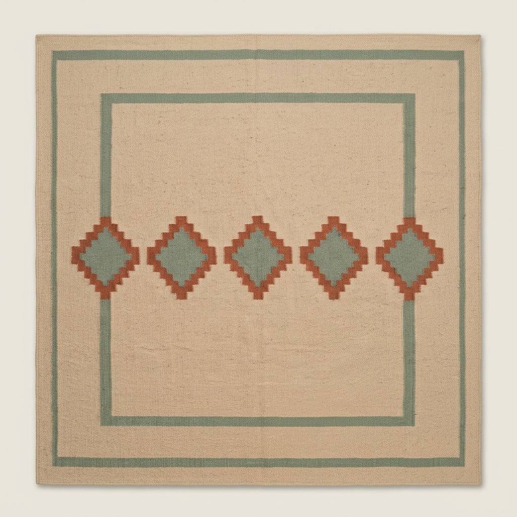 Southwestern Flatweave Wool Rug in beige with sage green borders and five terracotta diamonds with sage centres.