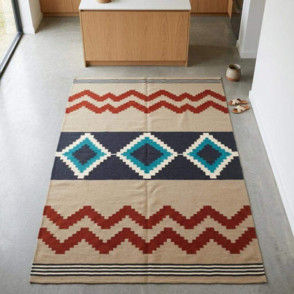 Southwestern flatweave wool rug with terracotta turquoise geometric diamond pattern in living room setting