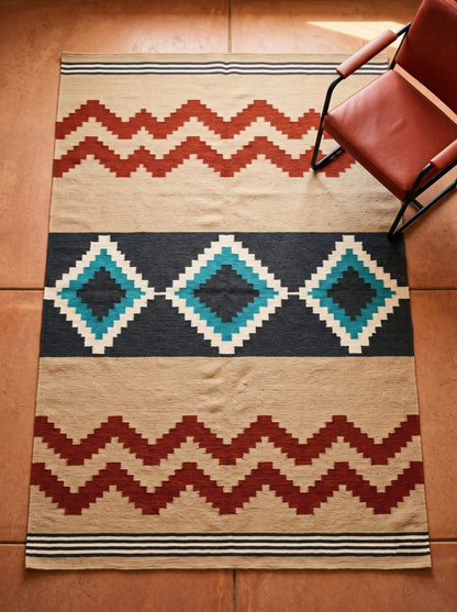 Southwestern flatweave wool rug with terracotta, turquoise, and geometric diamond patterns in living room decor
