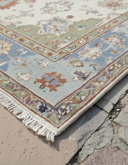 Terracotta Oushak wool rug with light blue floral and geometric patterns on burnt orange background