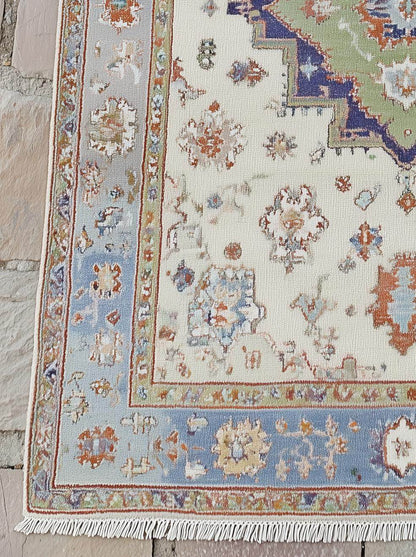 Hand-knotted terracotta Oushak wool rug with light blue floral and geometric patterns