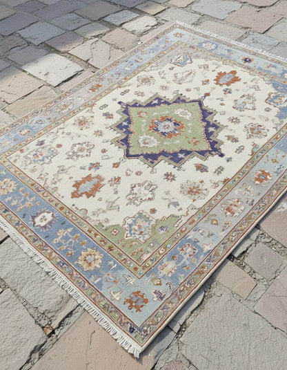 Terracotta Oushak wool rug with light blue floral oriental design and intricate hand-knotted craftsmanship