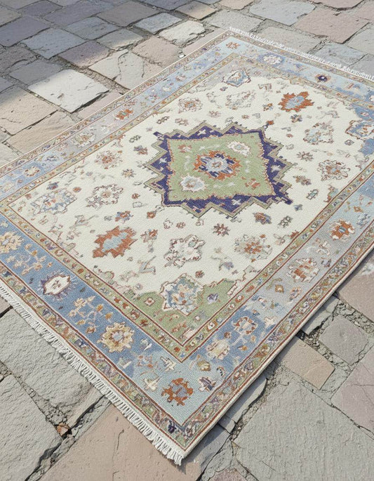 Terracotta Oushak wool rug with light blue floral oriental design and intricate hand-knotted craftsmanship